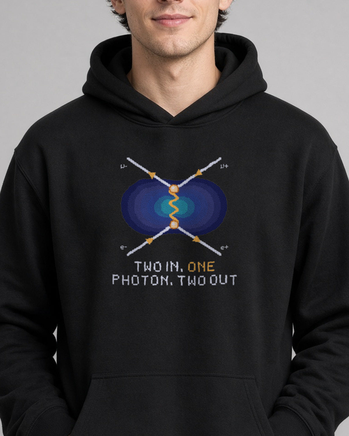 Black Feynman Diagram physics hoodie, pixel-art electron-positron annihilation design, worn by a model, front close-up