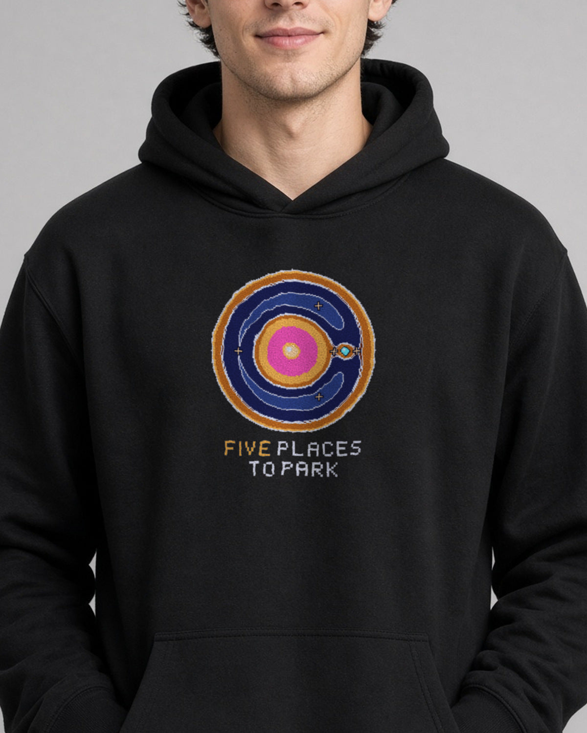 Black Lagrange Points physics hoodie, pixel-art Lagrange points design, worn by a model, front close-up