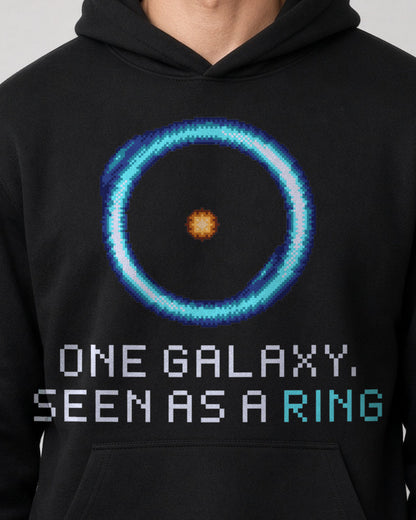 Black Einstein Ring physics hoodie, pixel-art gravitational lensing design, worn by a model, front close-up