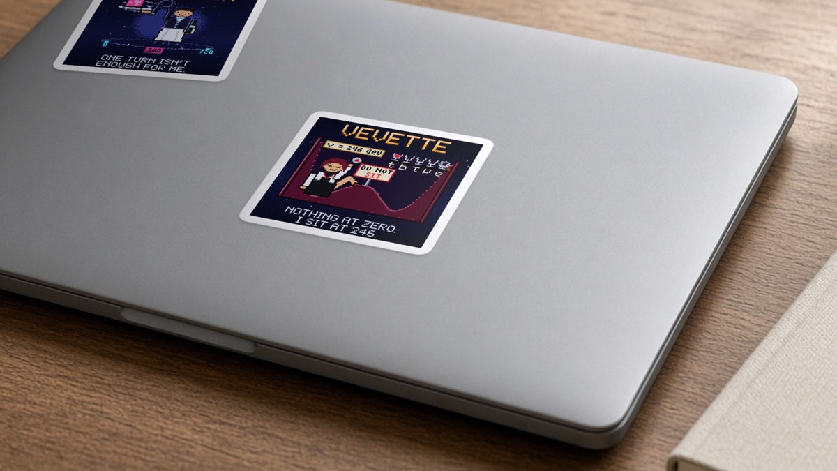 Vevette navy pixel-art physics sticker, Higgs field, on a laptop