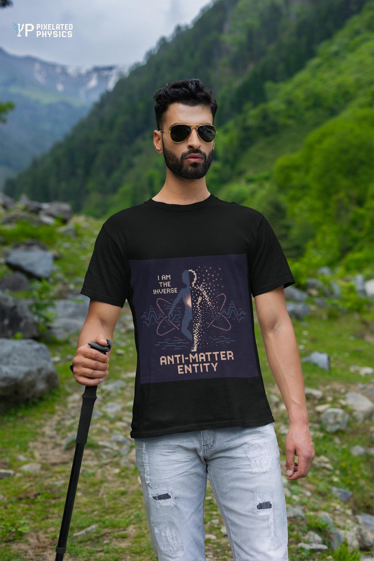 Black Anti-Matter Entity physics T-shirt, pixel-art matter–antimatter annihilation design, worn by a man outdoors