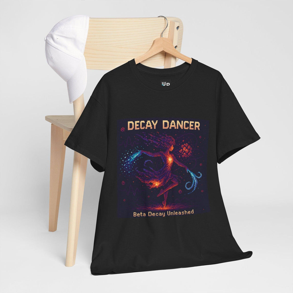 Black Decay Dancer physics T-shirt, pixel-art beta decay design, hanging on a chair