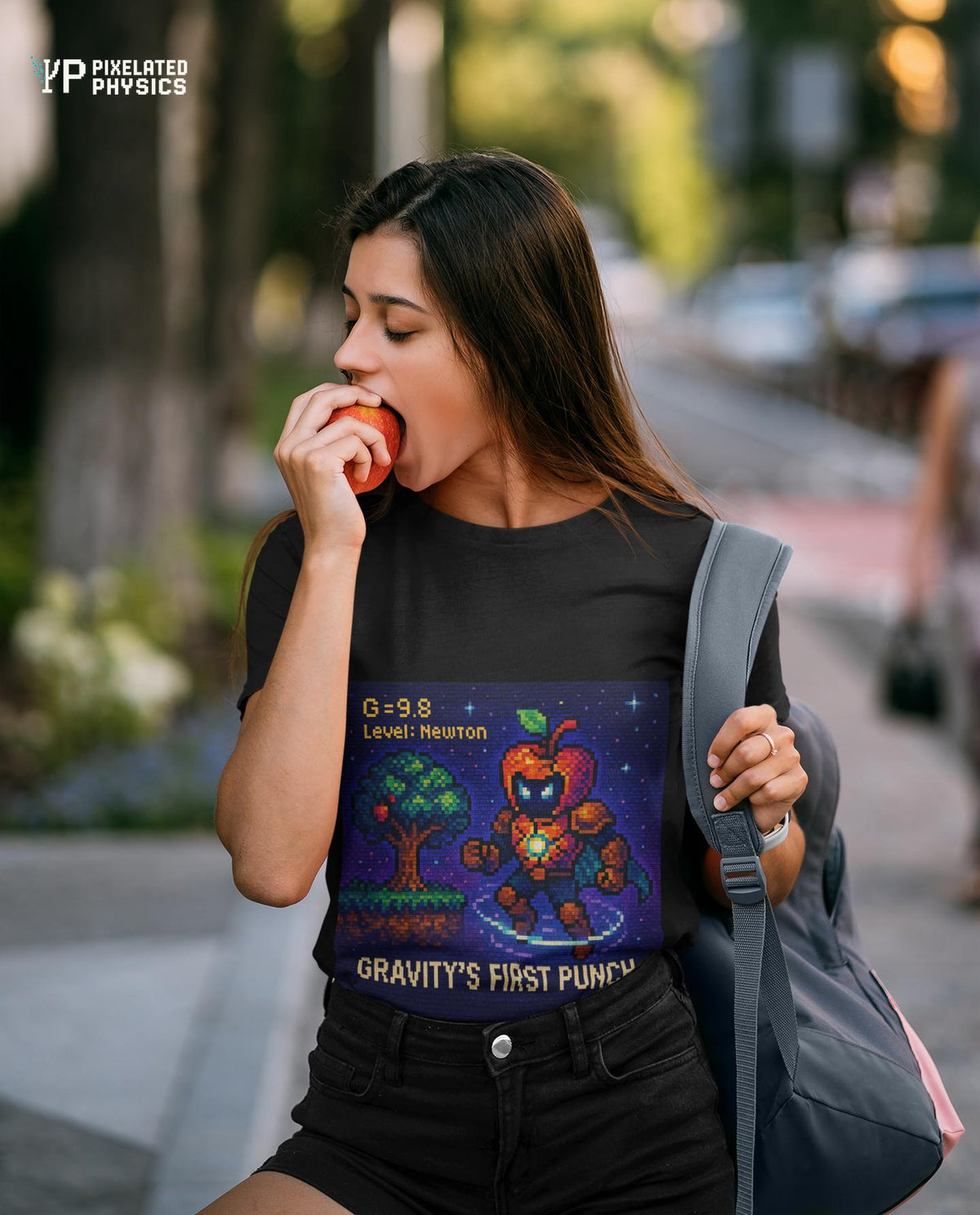 Black Gravity's First Punch physics T-shirt, pixel-art Newton’s law of gravitation design, worn by a woman