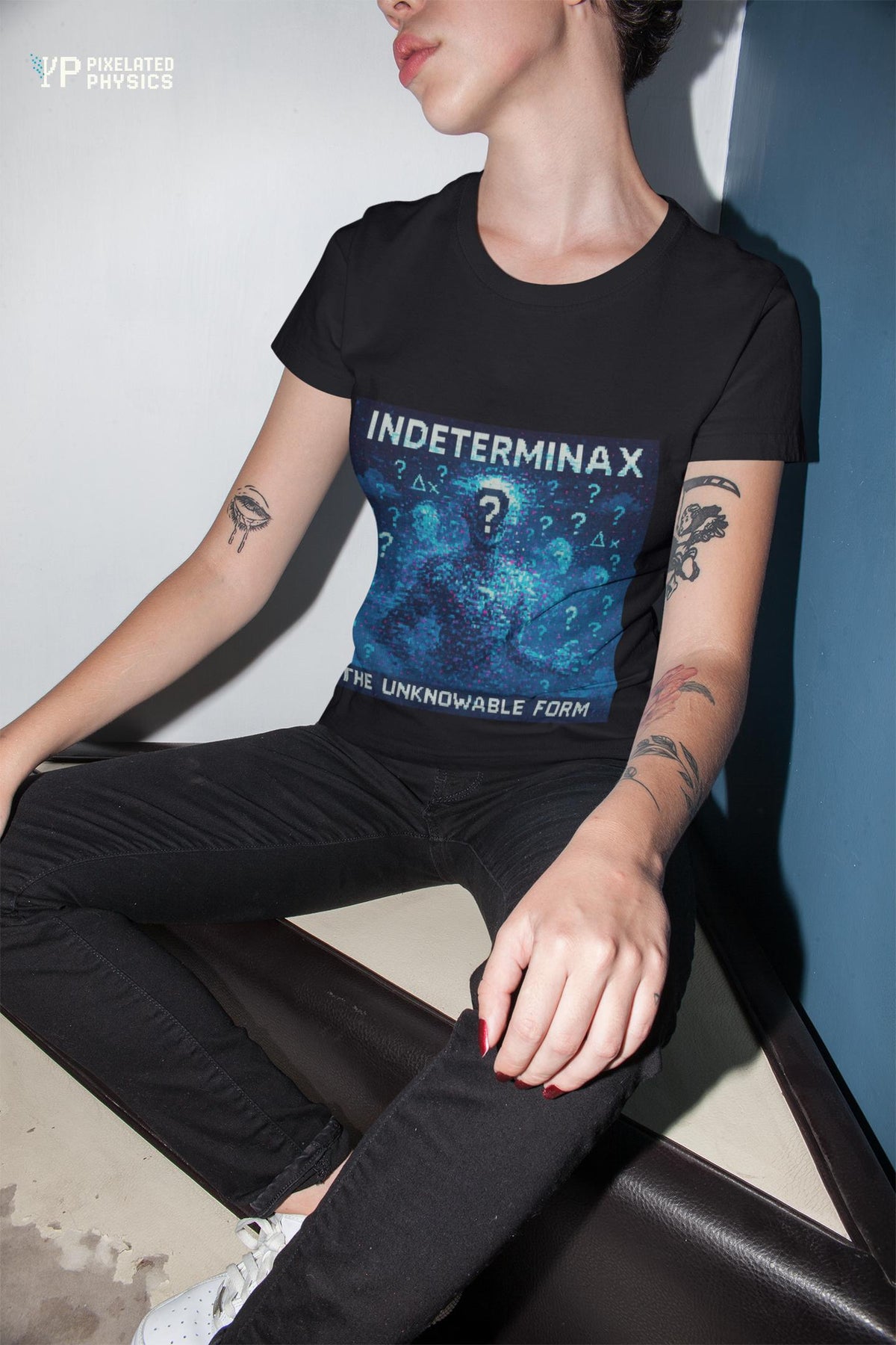 Black Indeterminax physics T-shirt, pixel-art uncertainty principle design, worn by a man