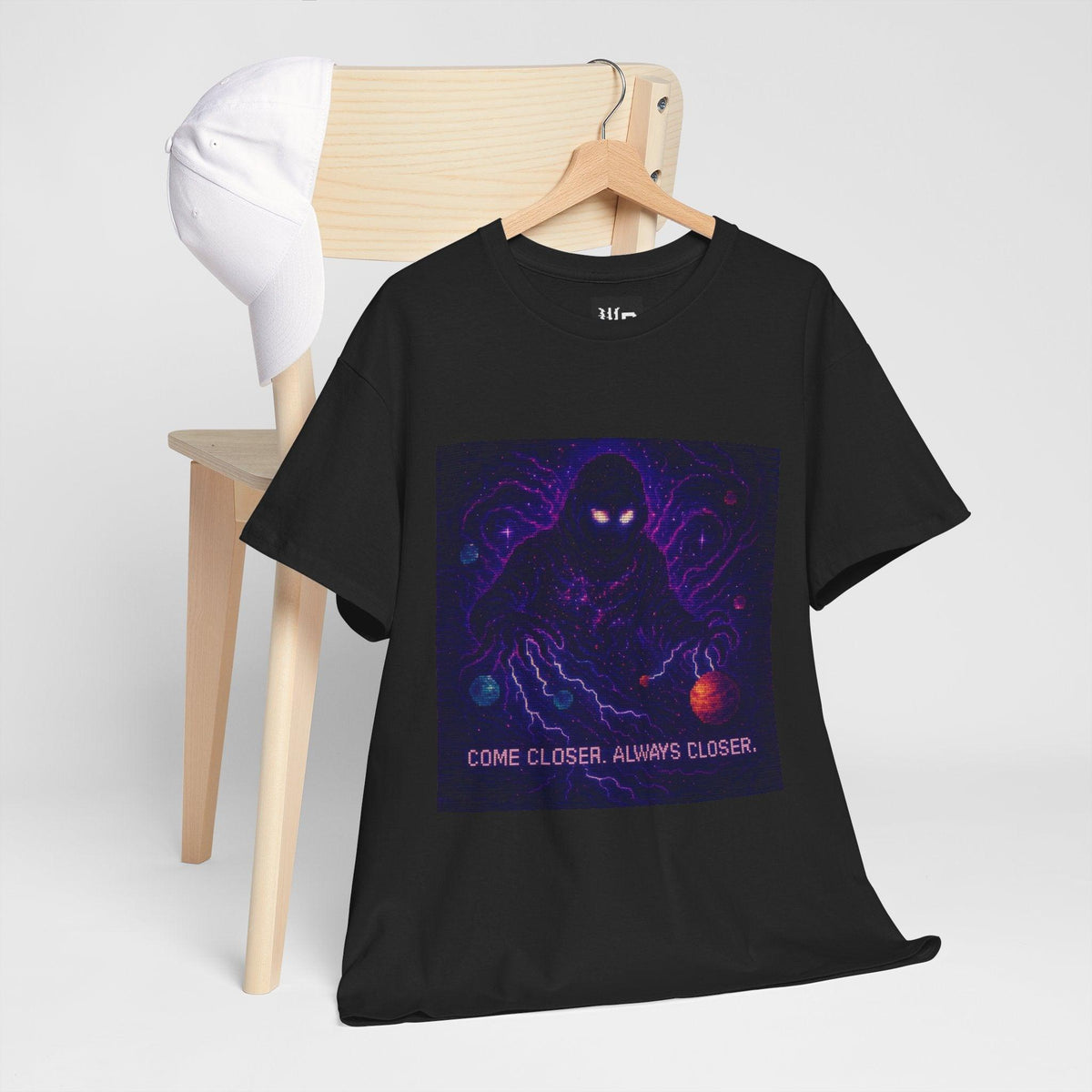 Black The Lurker physics T-shirt, pixel-art general relativity design, hanging on a chair