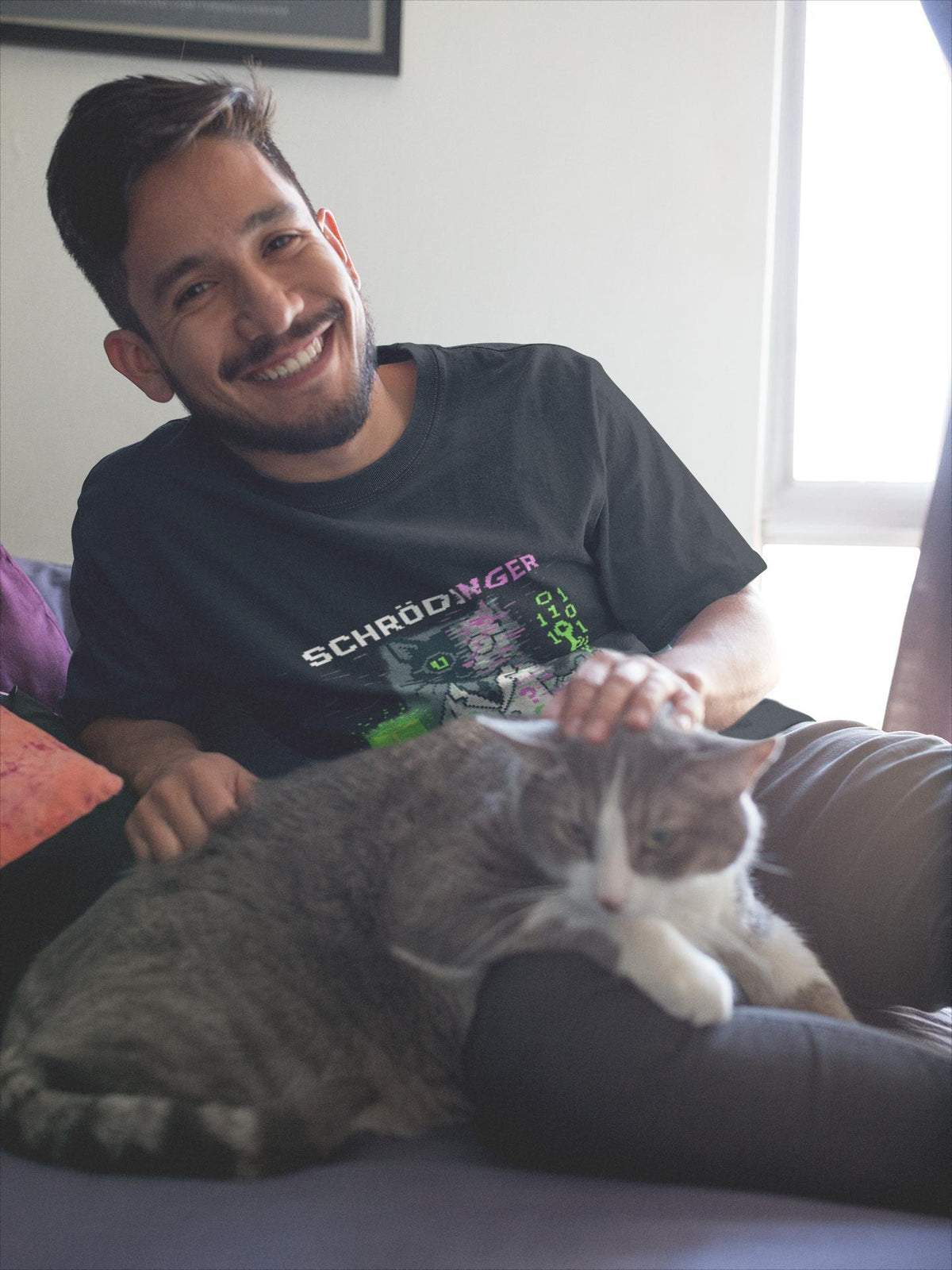 Black Schrödy physics T-shirt, pixel-art Schrödinger’s cat design, worn by a man with a cat