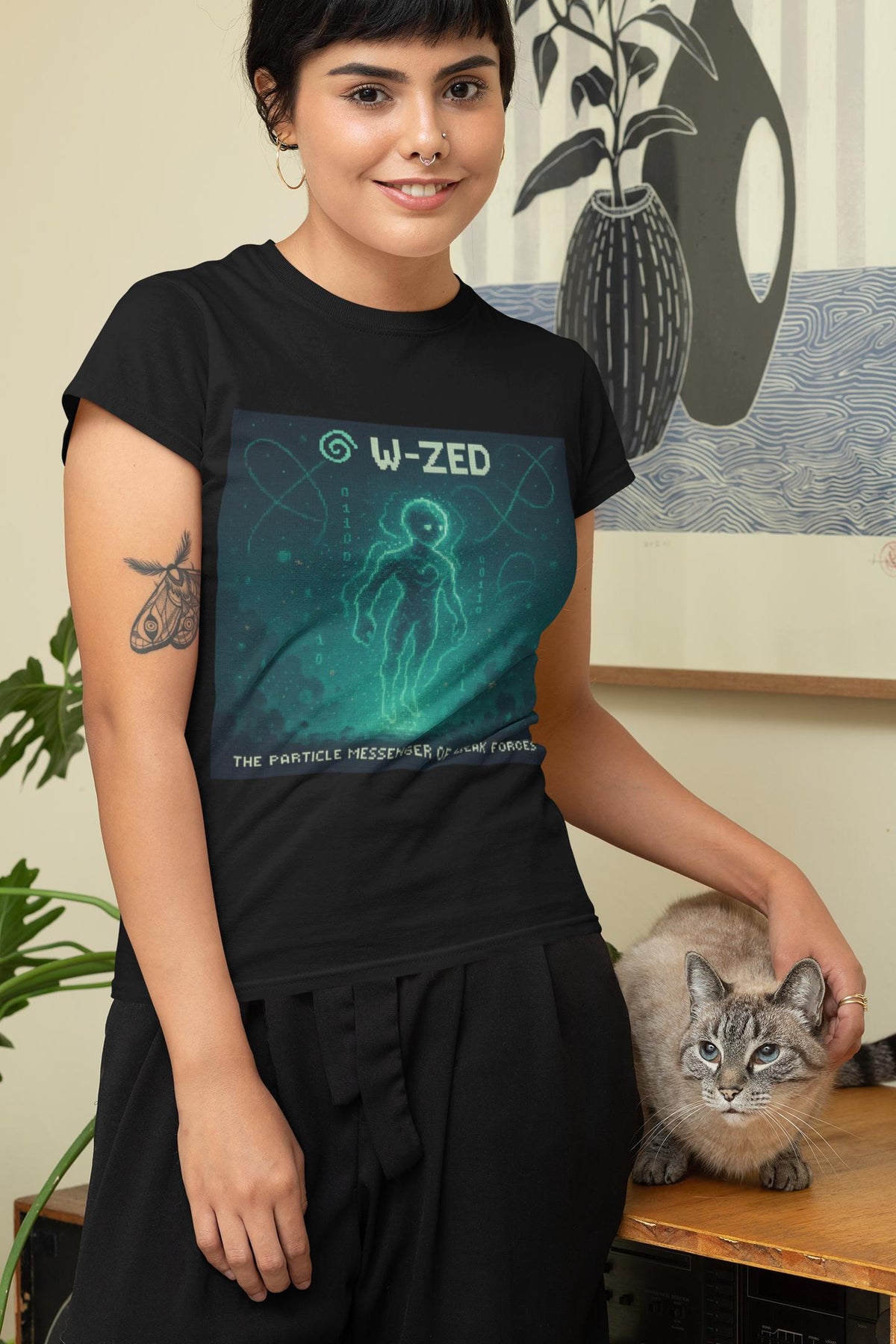 Black W-ZED physics T-shirt, pixel-art W and Z bosons, weak force design, worn by a woman