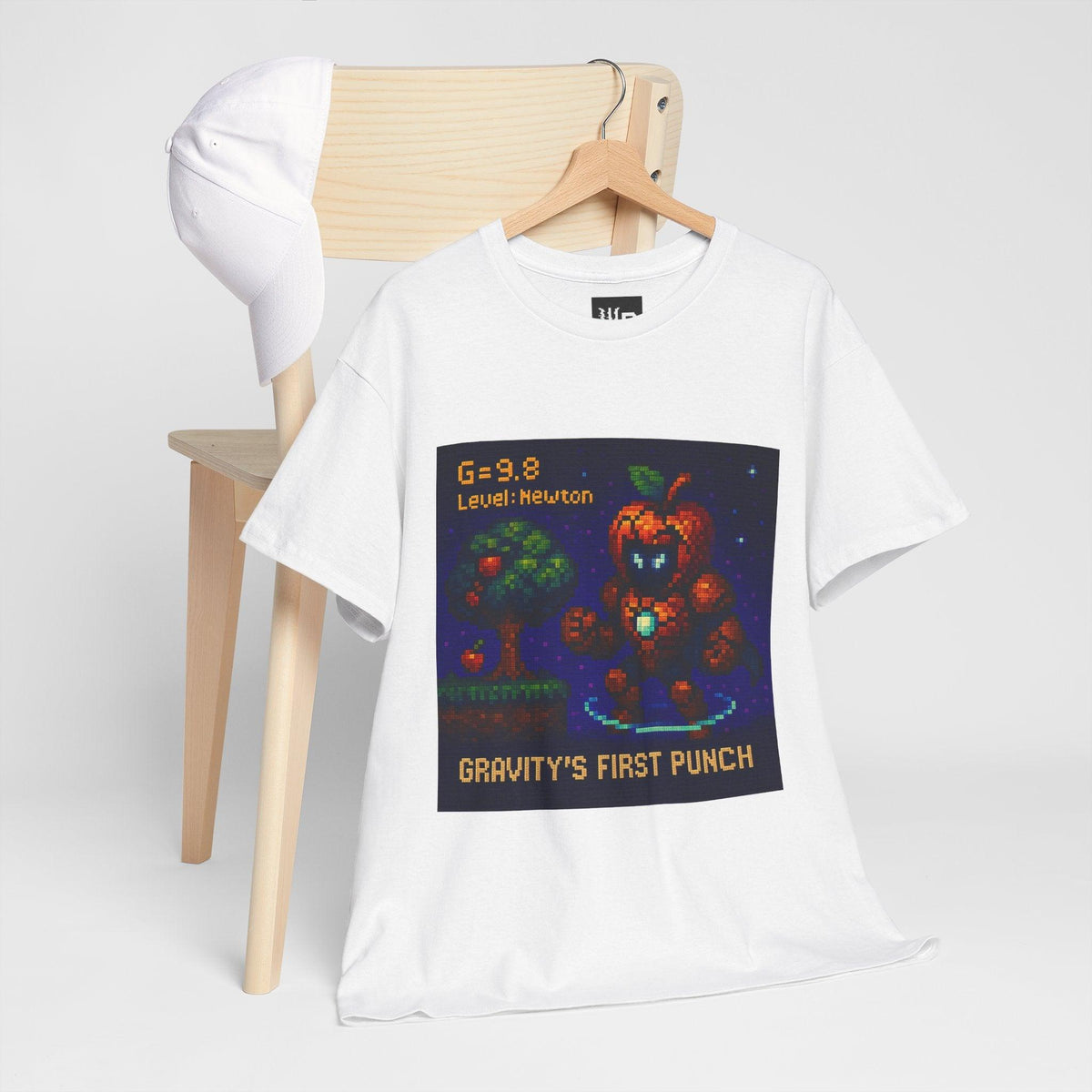 White Gravity's First Punch physics T-shirt, pixel-art Newton’s law of gravitation design, hanging on a chair