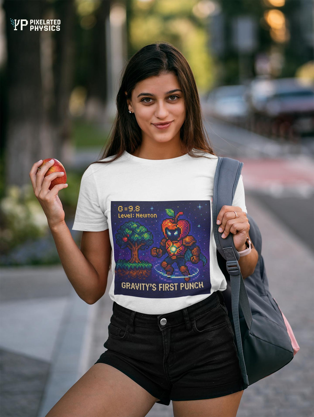 White Gravity's First Punch physics T-shirt, pixel-art Newton’s law of gravitation design, worn by a woman