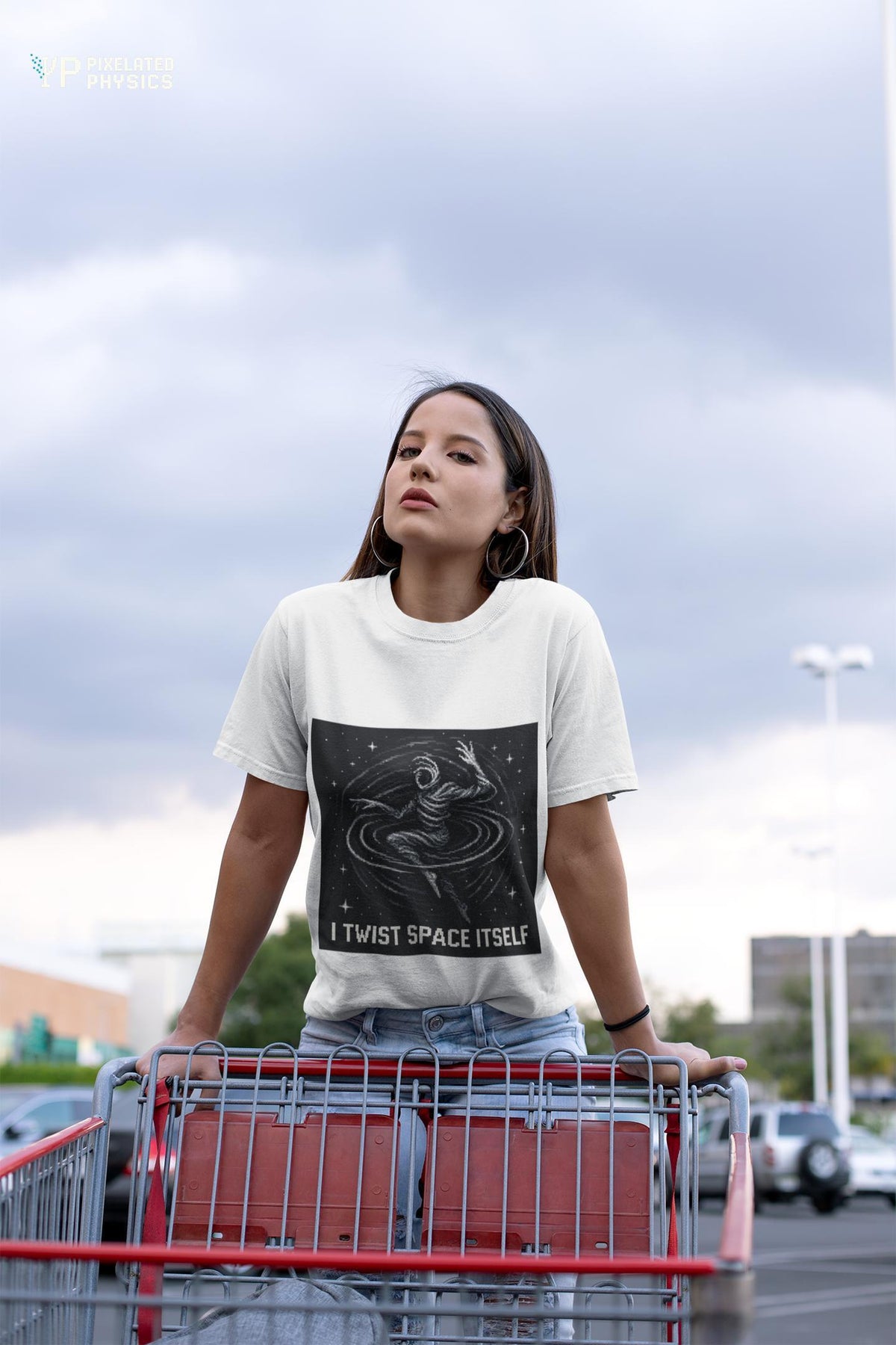 White I Twist Space Itself physics T-shirt, pixel-art gravitational lensing design, worn by a woman