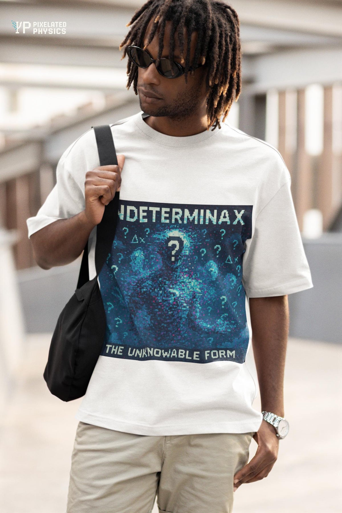 White Indeterminax physics T-shirt, pixel-art uncertainty principle design, worn by a man