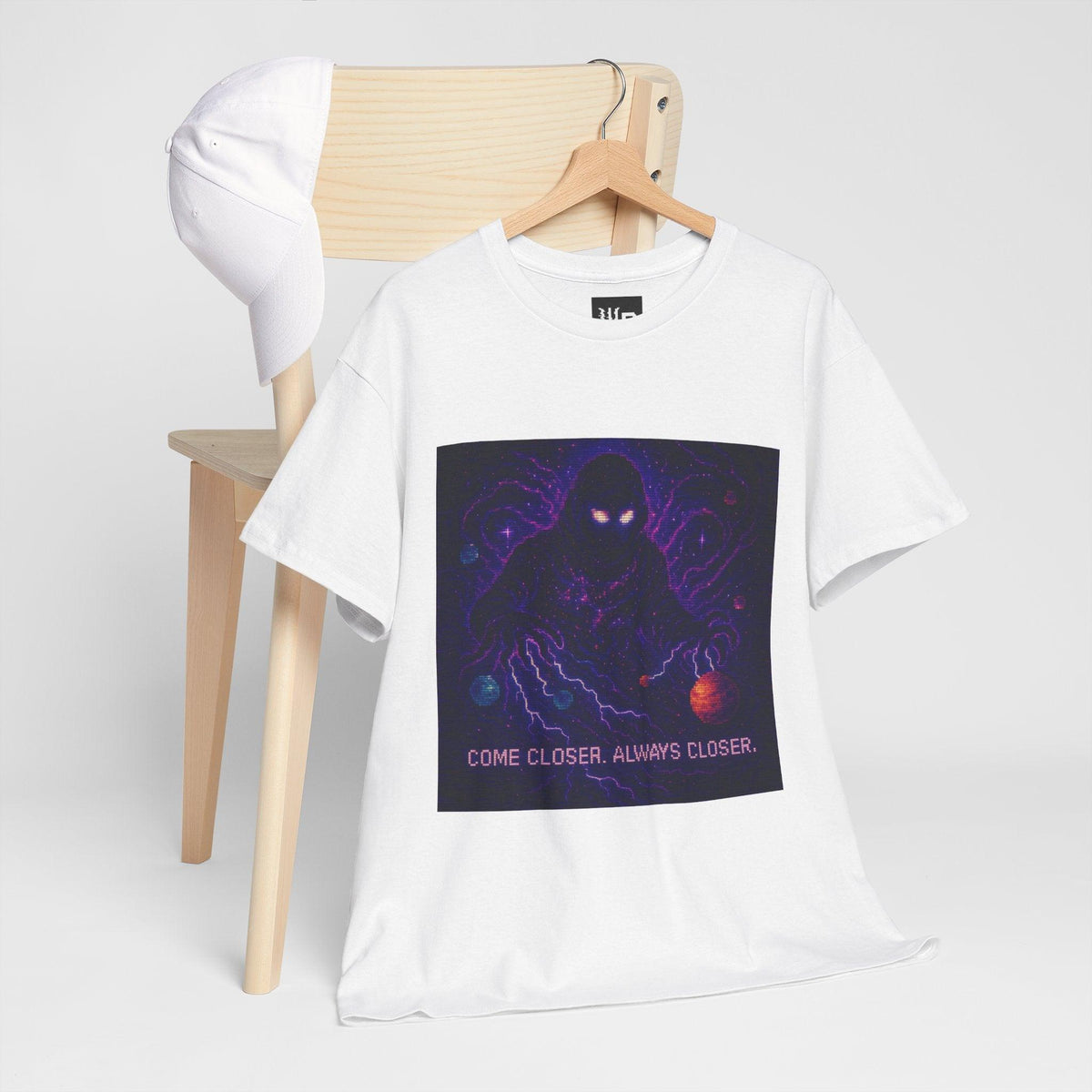 White The Lurker physics T-shirt, pixel-art general relativity design, hanging on a chair