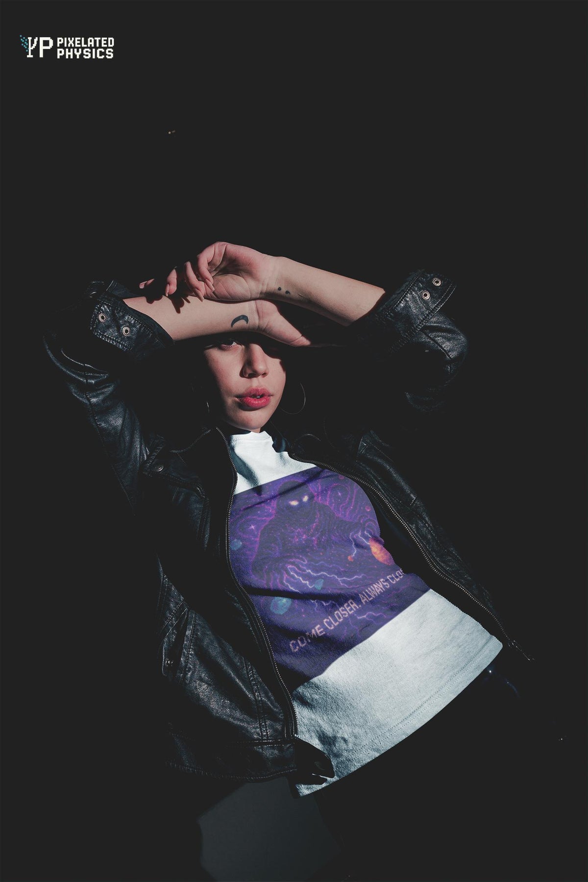 White The Lurker physics T-shirt, pixel-art general relativity design, worn by a woman in a leather jacket
