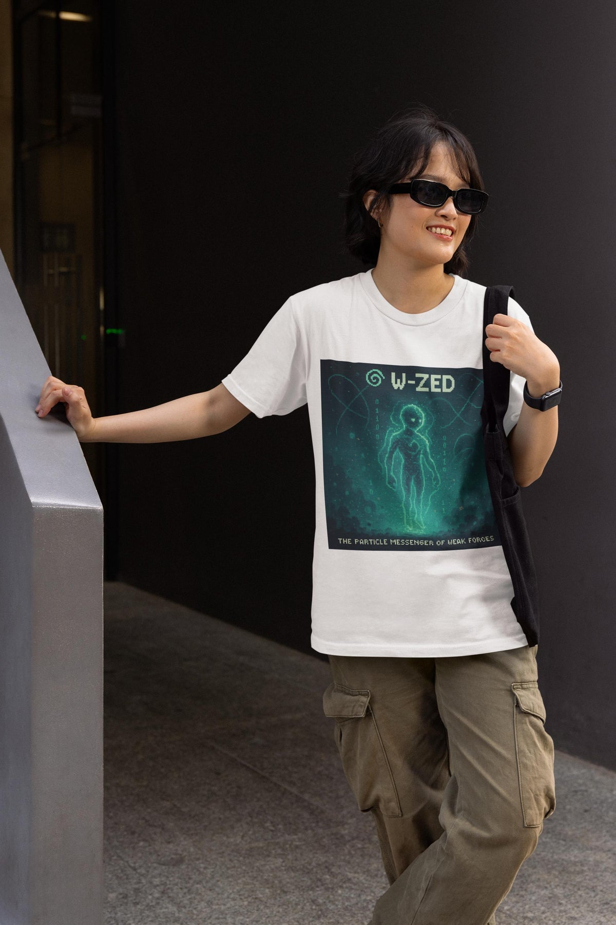 White W-ZED physics T-shirt, pixel-art W and Z bosons, weak force design, worn by a man